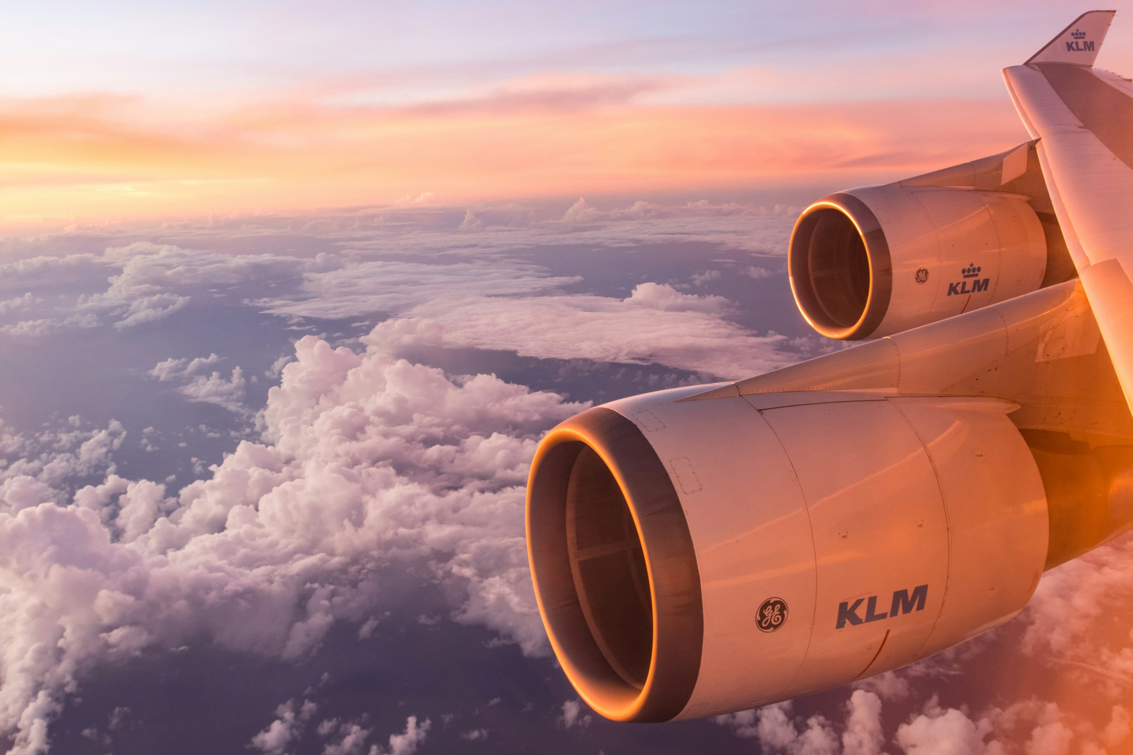 View from an airplane window above the clouds