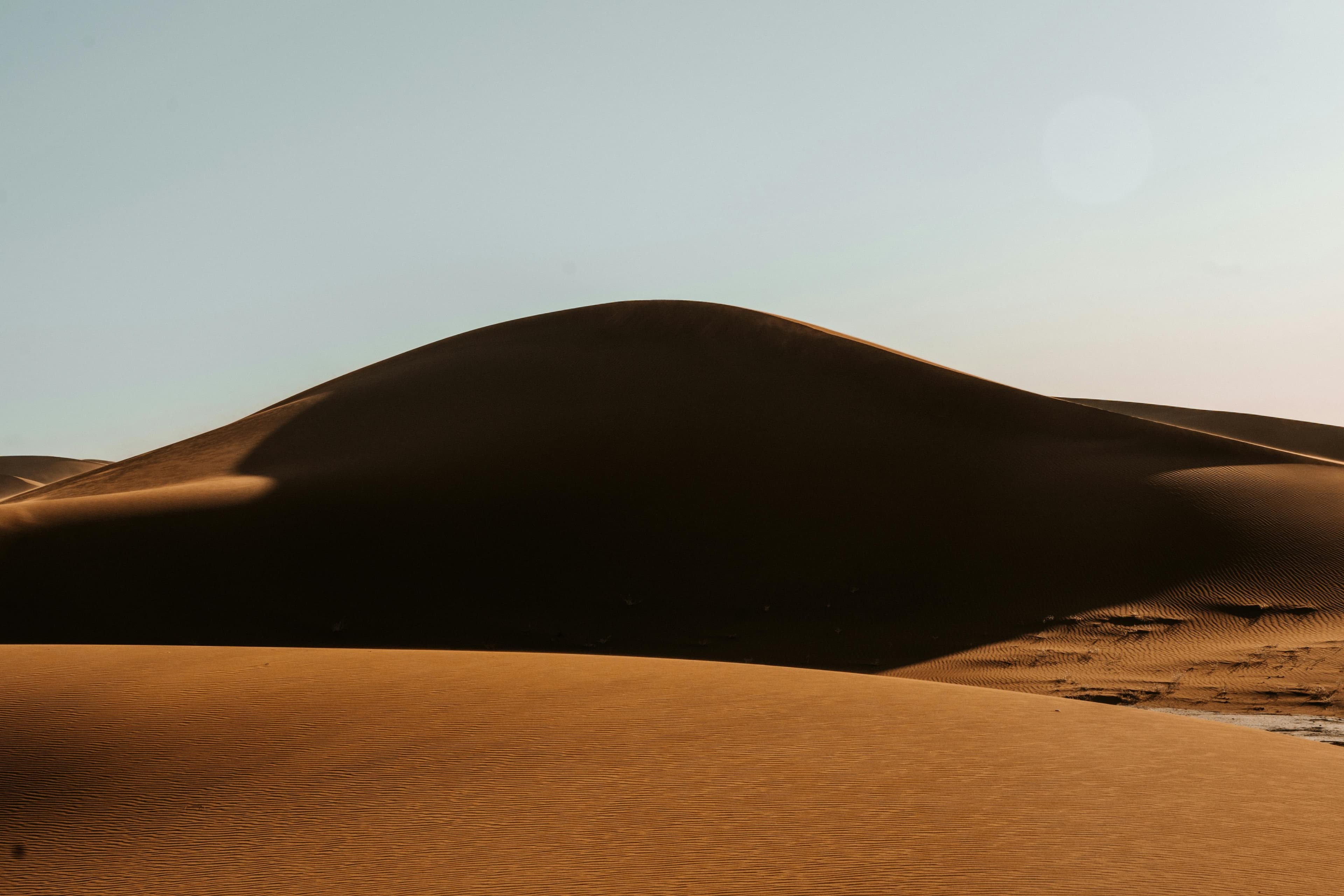 Sand dunes at dusk behind the Sandbox title