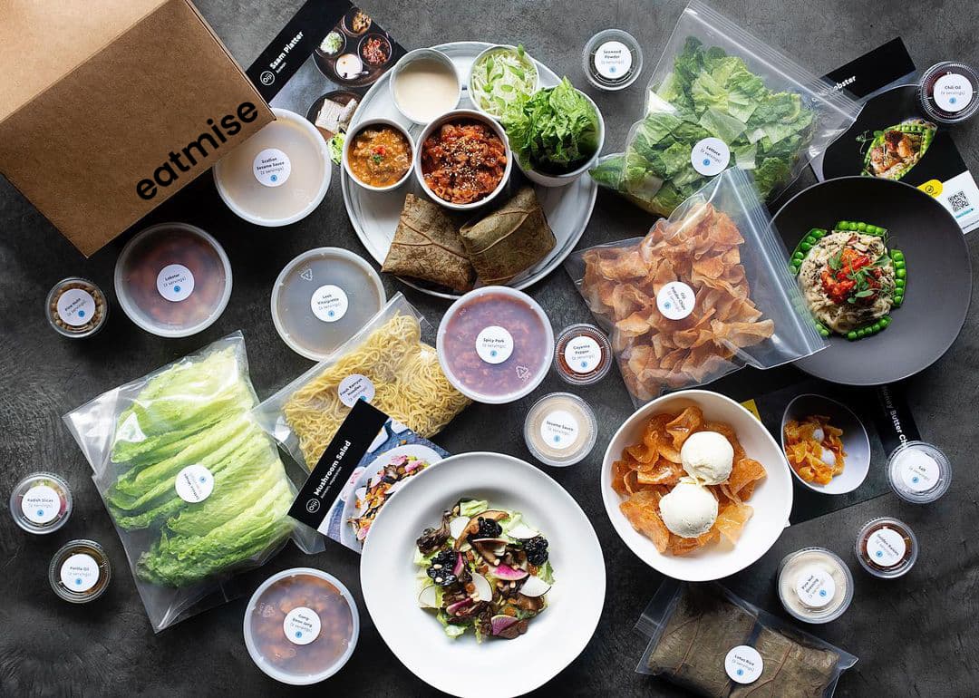 Overhead spread of EatMise meal kit ingredients and packaging