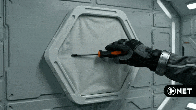 Gloved hand pressing a screwdriver into the expandable N.E.T. textile surface